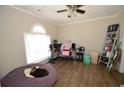 Bedroom with a large window, wood floors, and a comfortable beanbag chair at 5647 Executive Way, Norcross, GA 30071