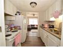Cozy kitchen with white appliances and cabinets, and granite countertops at 5647 Executive Way, Norcross, GA 30071