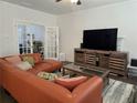 Cozy living room with a leather couch and a decorative entertainment center at 1200 Bar Harbor Pl, Lawrenceville, GA 30044