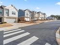 Charming street view of newly built townhomes in a well maintained neighborhood at 130 Maple Creek Way, Woodstock, GA 30188