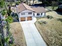 Aerial shot of a stunning two-story home with a long driveway and expansive front yard, freshly painted at 406 Jordan Dr, Tucker, GA 30084