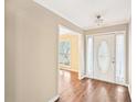 Bright foyer with hardwood floors, white trim, and a view into an adjacent room with natural light at 105 Spring Forest Way, Sharpsburg, GA 30277