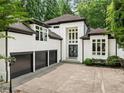 Beautiful home with a three-car garage and a modern, clean white exterior at 4000 Wieuca Ne Rd, Atlanta, GA 30342
