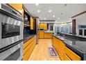 A modern eat-in kitchen features stainless steel appliances, granite countertops, and wood cabinetry at 4000 Wieuca Rd Ne, Atlanta, GA 30342