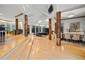 An expansive living room features hardwood floors, exposed beams and pillars, and plenty of natural light at 4000 Wieuca Rd Ne, Atlanta, GA 30342
