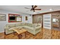 Spacious living room featuring hardwood floors, brick accents and a large sectional sofa perfect for relaxation at 7030 Cascade Palmetto Hwy, Palmetto, GA 30268