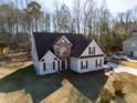A stunning aerial view of a two-story home with stone facade and a well-manicured front yard at 205 Trelawney Place, Covington, GA 30016
