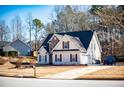 Charming two-story home with a stone facade, attached garage, and a well-manicured front yard with lovely curb appeal at 205 Trelawney Place, Covington, GA 30016