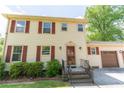 Inviting two-story home featuring red shutters, a beautiful front door and manicured front yard at 5678 Fern Creek Sw Dr, Lilburn, GA 30047