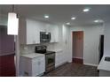 Modern kitchen featuring white cabinets, stainless steel appliances, and elegant countertops at 5678 Fern Creek Sw Dr, Lilburn, GA 30047