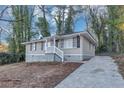 Single Gathering home featuring a cozy front porch and driveway at 1834 Hillsdale Dr, Decatur, GA 30032