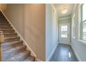 Welcoming entryway with a staircase, wood flooring, and natural lighting at 258 Depot Landing Rd # 53, Auburn, GA 30011
