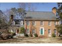 Classic brick home with manicured lawn, mature trees and a welcoming green front door at 270 Grapevine Run, Sandy Springs, GA 30350