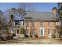Charming brick two-story home with a well-manicured lawn, and a colorful front door at 270 Grapevine Run, Sandy Springs, GA 30350