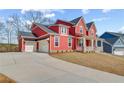 Beautiful two-story red home with a two-car garage and inviting front porch at 4039 Andover Cir, Mcdonough, GA 30252