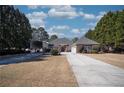 Traditional brick home with mature trees and a long driveway leading to the residence at 520 Camp Perrin Rd, Lawrenceville, GA 30043