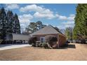 Home shows a glimpse of a metal carport, lush greenery, and a well-manicured lawn at 520 Camp Perrin Rd, Lawrenceville, GA 30043