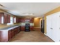 Functional kitchen featuring black appliances, laminate countertops, and dark cabinetry at 7635 Jumpers Trl, Fairburn, GA 30213