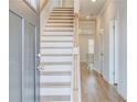 Inviting entryway with hardwood floors and staircase leading to the upper level at 249 Chiswick Loop, Stockbridge, GA 30281