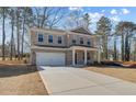 Charming two-story brick home with a well-manicured lawn and attached two-car garage at 249 Chiswick Loop, Stockbridge, GA 30281