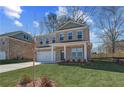 Charming two-story brick home with a well-manicured lawn and attached two-car garage at 249 Chiswick Loop, Stockbridge, GA 30281