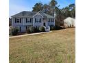 Attractive two-story home with neutral siding, complemented by a lush front yard at 7603 Autumn Breeze, Douglasville, GA 30134