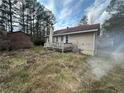 Expansive backyard with a wooden deck, enveloped by lush trees offering privacy and serene outdoor space at 87 Brushy Path, Rockmart, GA 30153