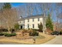 Charming two-story brick home with a well-manicured lawn and beautiful landscaping at 9625 River Lake Dr, Roswell, GA 30075