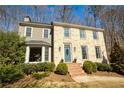 Inviting brick home with a manicured lawn, featuring a light blue front door at 9625 River Lake Dr, Roswell, GA 30075