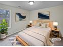 Cozy bedroom featuring neutral décor, a large bed with bedside tables and stylish blue-themed artwork at 1835 Big Haynes Ct, Grayson, GA 30017