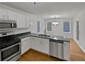 Well-lit kitchen boasts sleek countertops, modern appliances, and an adjacent dining area with a window view at 1835 Big Haynes Ct, Grayson, GA 30017