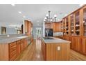 Expansive kitchen with wood cabinets, central island cooktop, modern appliances, and hardwood flooring at 716 Counsel Ne Dr, Marietta, GA 30068