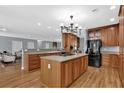 Large kitchen with a central island and cooktop, wood cabinetry, and seamless access to a sitting area at 716 Counsel Ne Dr, Marietta, GA 30068