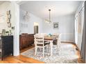 Elegant dining room with a wooden table, chandelier lighting, and hardwood floors at 3740 Cannonwolde Dr, Snellville, GA 30039