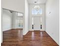 Bright entryway featuring a soaring ceiling, chandelier, and hardwood floors at 6272 Cheatham Lake Nw Dr, Acworth, GA 30101