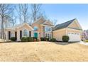 Traditional two-story home featuring stone accents, a manicured lawn, and a two-car garage at 6272 Cheatham Lake Nw Dr, Acworth, GA 30101