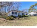 Cozy single-story home with manicured front bushes and a well-maintained lawn at 8523 Duncan St, Douglasville, GA 30134