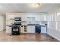 Bright kitchen with stainless steel appliances, ample counter space, and wooden floors at 8523 Duncan St, Douglasville, GA 30134