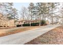 A beautiful suburban home, featuring a long driveway and mature trees at 123 Creek Cir, Stockbridge, GA 30281