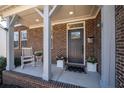 Inviting front porch featuring a rocking chair and potted plants, creating a warm and welcoming entrance at 139 Stargaze Rdg, Canton, GA 30114