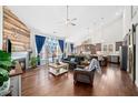 Cozy living room with a fireplace, hardwood floors, vaulted ceilings, and an open layout to the modern kitchen at 139 Stargaze Rdg, Canton, GA 30114