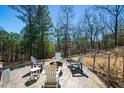 Stamped concrete patio with fire pit and seating surrounded by mature trees at 139 Stargaze Rdg, Canton, GA 30114