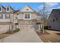 Charming townhome with stone facade and attached two-car garage, perfect for modern living at 3238 Spicy Cedar Ln, Lithonia, GA 30038