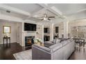 Open-concept living room featuring a fireplace, coffered ceilings, and hardwood floors at 3238 Spicy Cedar Ln, Lithonia, GA 30038