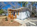 Side view of a well-kept home with wood porch and gray siding at 3687 Venus Nw Pl, Atlanta, GA 30331