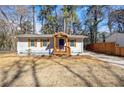 Attractive single-story home with a blue door and a well-maintained front yard at 3687 Venus Nw Pl, Atlanta, GA 30331