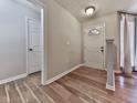 Inviting entryway with a wood-look flooring and a bright, modern door at 5228 Boone Ct, Villa Rica, GA 30180
