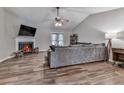 Comfortable living room with fireplace, wood floors and vaulted ceiling with fan at 5228 Boone Ct, Villa Rica, GA 30180