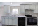 Bright kitchen featuring white marble countertops, modern appliances, and a stainless-steel faucet at 62 W Lakeview Dr, Temple, GA 30179