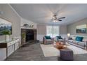Inviting living room featuring a stone fireplace, comfortable seating, and plenty of natural light at 62 W Lakeview Dr, Temple, GA 30179